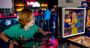 pinball game, redhead child, arcade, green shirt, Dolly Parton