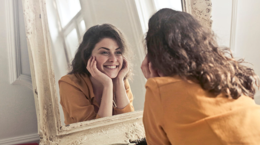 woman talking to herself, looking in the mirror, self-talk, happy woman, communication skills
