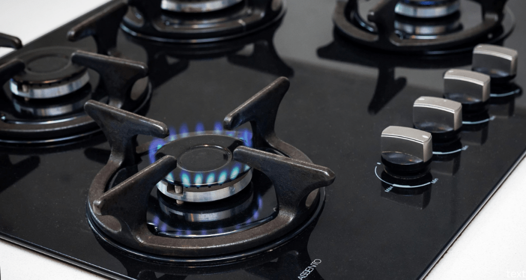 gas stove, black stovetop, natural gas, white countertop, cooking surface