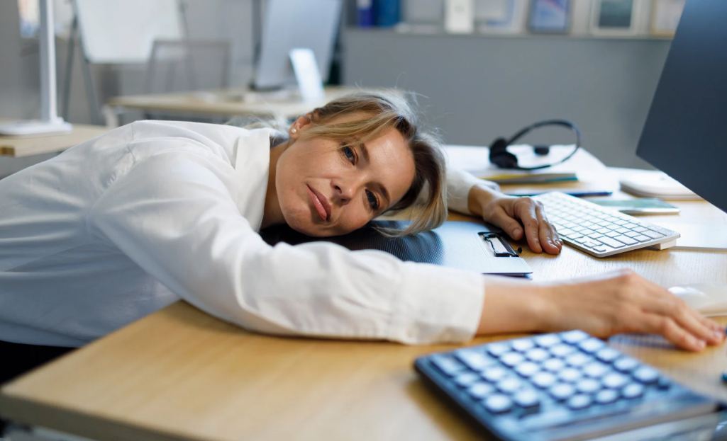 burnout, burnt out woman, tired worker, tired employee, woman on desk