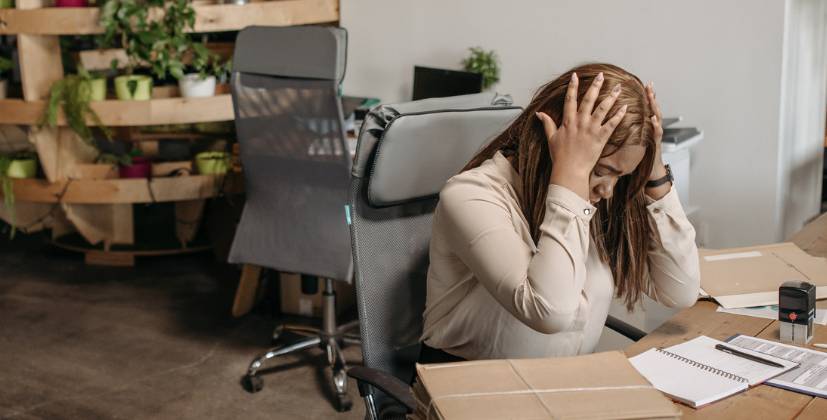 upset woman, woman in office, distressed woman, woman at desk, woman at work
