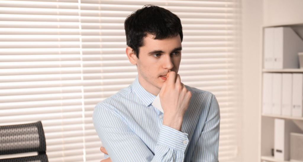 timid man, shy guy, scared at work, young man, office,