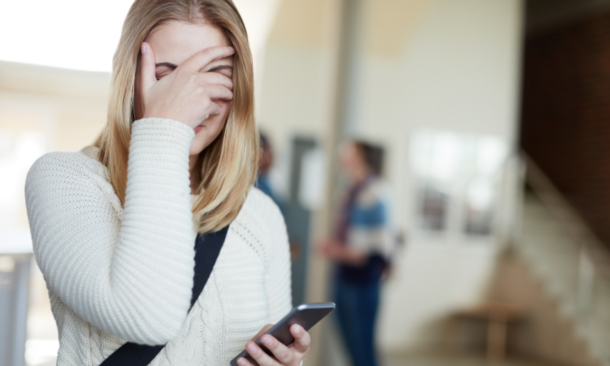 female student, upset student, student with smartphone, college woman, white sweater