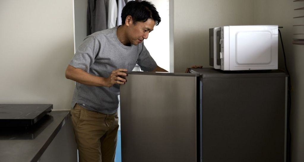 man opening refrigerator, fridge, microwave