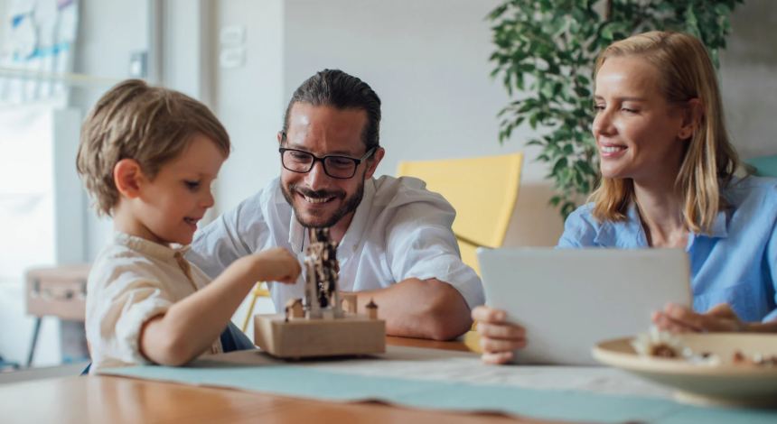 parents, child, kitchen table, parents playing game, young boy, family time