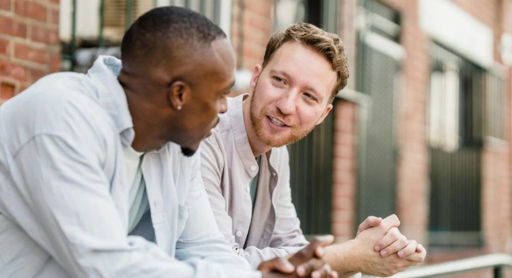 man talking, men chatting, sharing opinions, casual conversation, hands folded