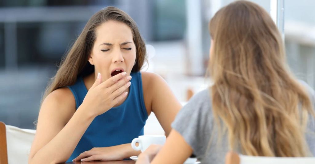 yawning, bored, not listening, communications skills, woman in blue