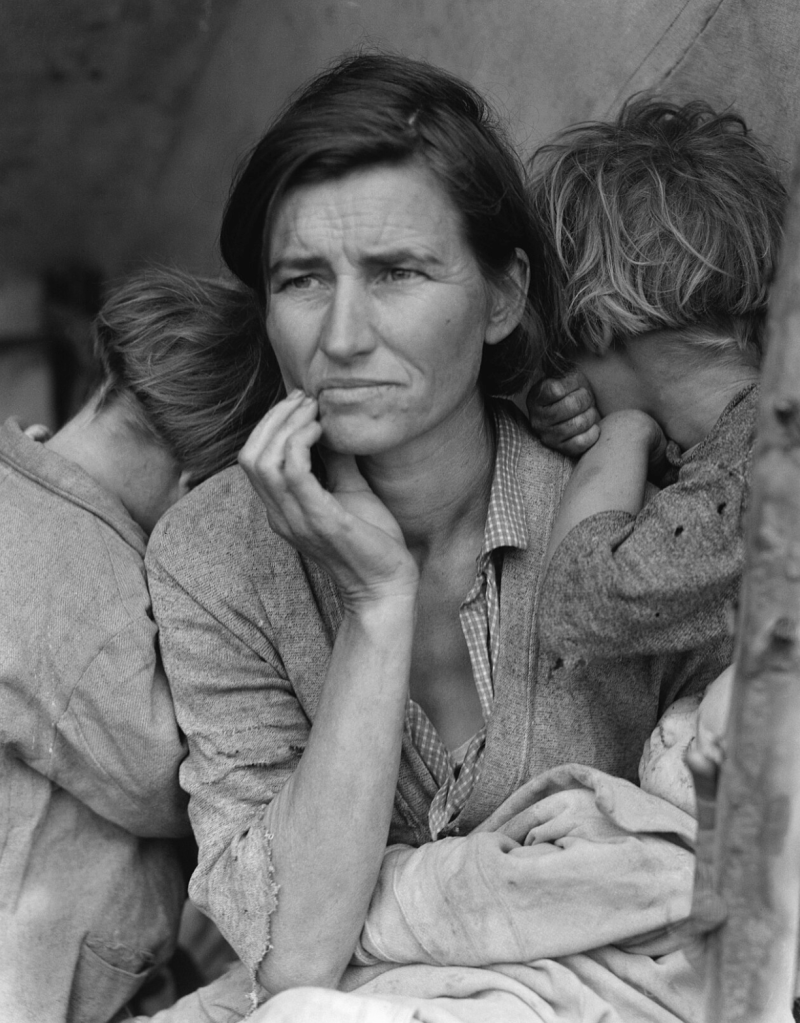 Dorothea Lange's 1936 "Migrant Mother" photo of Florence Owens Thompson, her hand raised to her chin in worry, flanked by two children with their faces turned away and an infant in her lap.