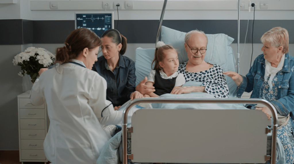 A senior man in a hospital bed being comforted by his family.