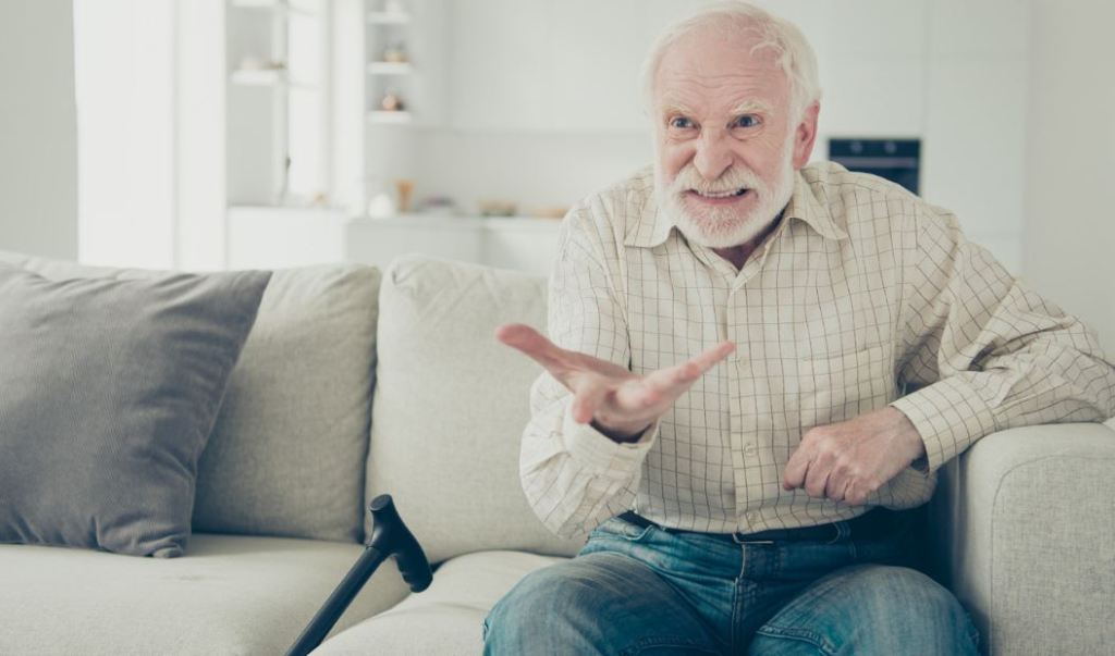 angry boomer, baby boomer, man on couch, older man, man with cane