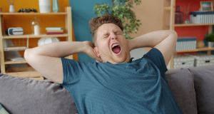 Gen X man, couch, yawning