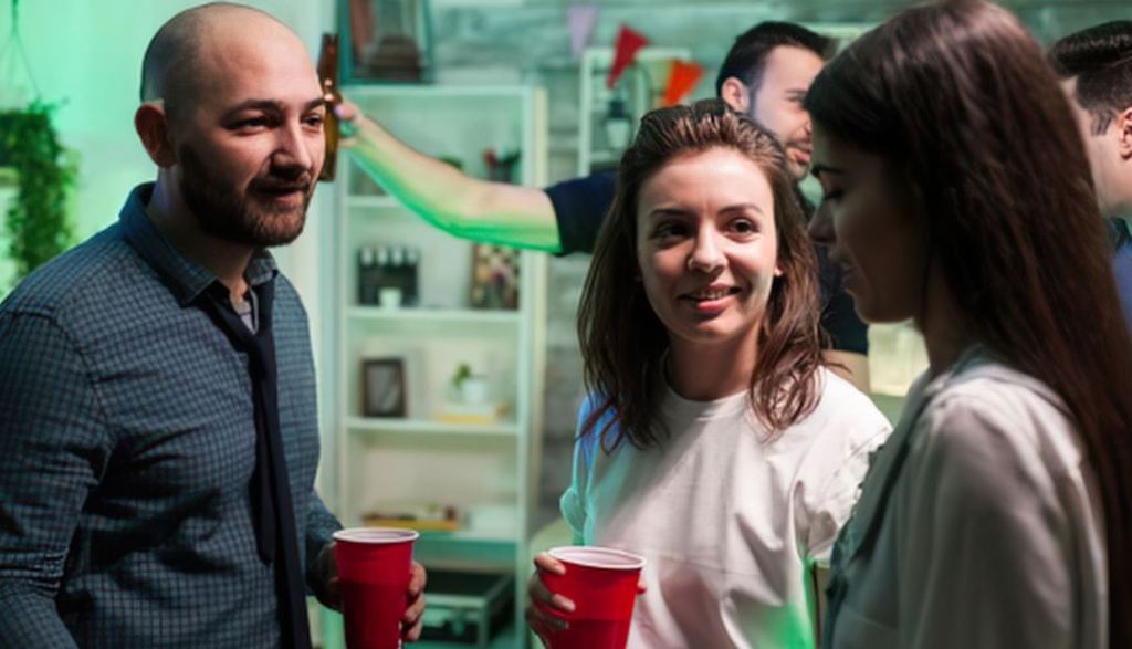 red cups, party, party conversation, two women, man, kitchen,