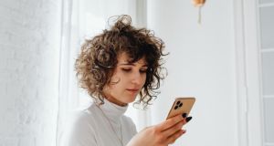 phone, scrolling on phone, doom scrolling, posting on social media, woman looking at phone