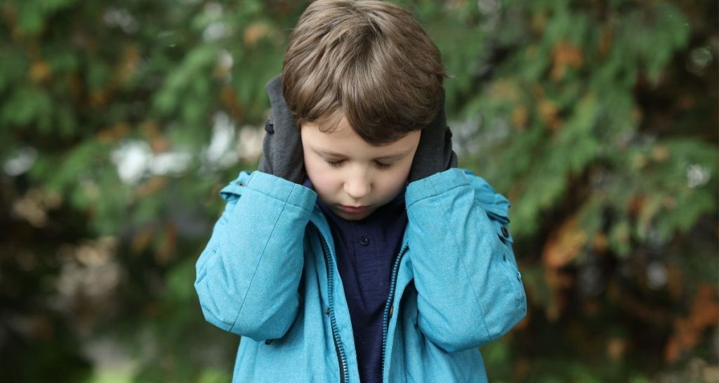 child, ears covered, parenting tips